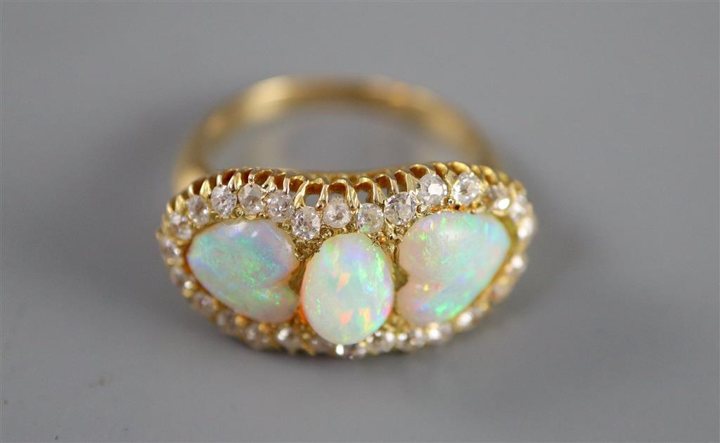 A gold, three stone white opal and diamond set cluster ring,
